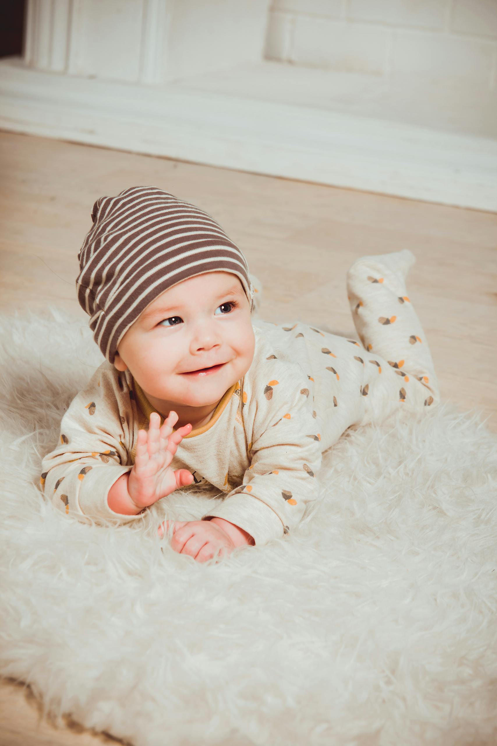 Smiling Baby Lying on White Mat